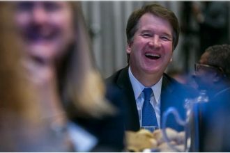 U.S. Supreme Court Justice Brett Kavanaugh listens to a discussion between Economic Club President David Rubenstein and NBA Commissioner Adam Silver about the state of the NBA and professional sports during and event hosted by the Economic Club of Washington, D.C. at the Capitol Hilton on May 9, 2019 in Washington, DC.