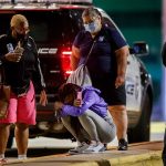 A woman kneels on the ground outside the University of Chicago Medicine's Comer Children's Hospital where an 8-year-old girl was taken after being killed in a shooting during the Labor Day weekend Monday, Sep. 7, 2020, in Chicago. (Armando L. Sanchez/Chicago Tribune/Tribune News Service via Getty Images)