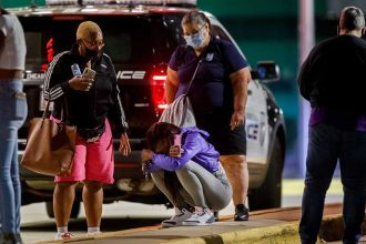 A woman kneels on the ground outside the University of Chicago Medicine's Comer Children's Hospital where an 8-year-old girl was taken after being killed in a shooting during the Labor Day weekend Monday, Sep. 7, 2020, in Chicago. (Armando L. Sanchez/Chicago Tribune/Tribune News Service via Getty Images)