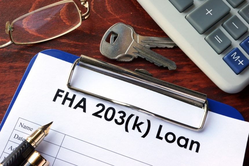Clipboard with FHA 203k loan form in an office.
