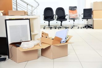 Move concept. Unpacking cardboard boxes in a new office
