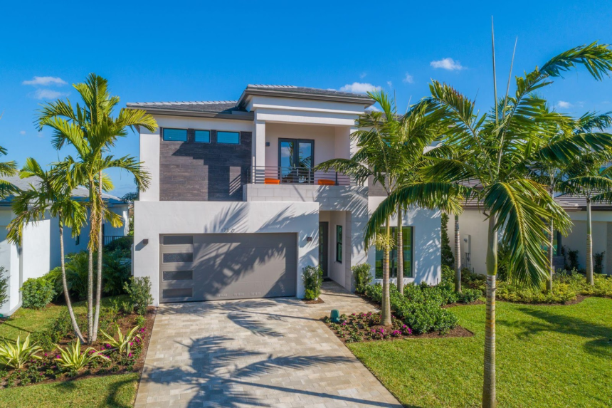 A picture of the home exterior for the GL Homes Caledonia plan at Lotus Palm in the Fiji collection, located in Boca Raton, Florida.