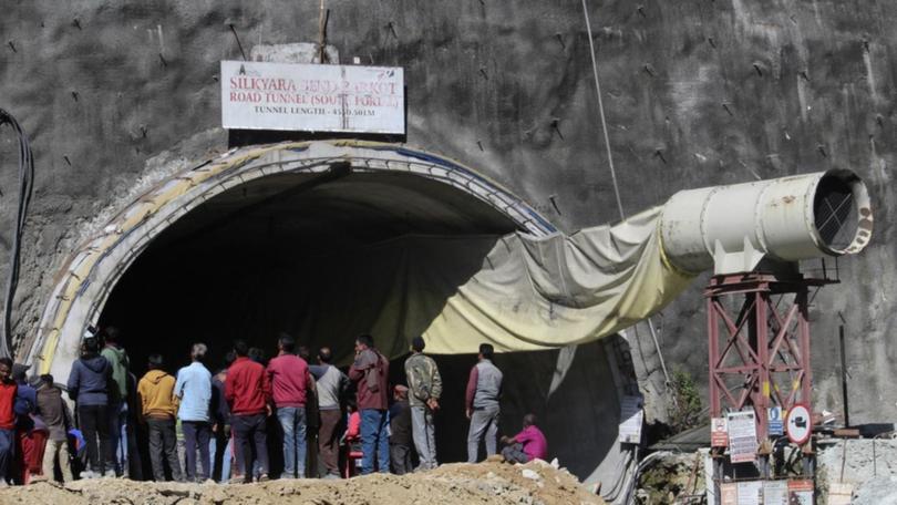 Indian rescuers drill through rubble to rescue workers trapped.