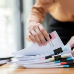business woman handling files on desk