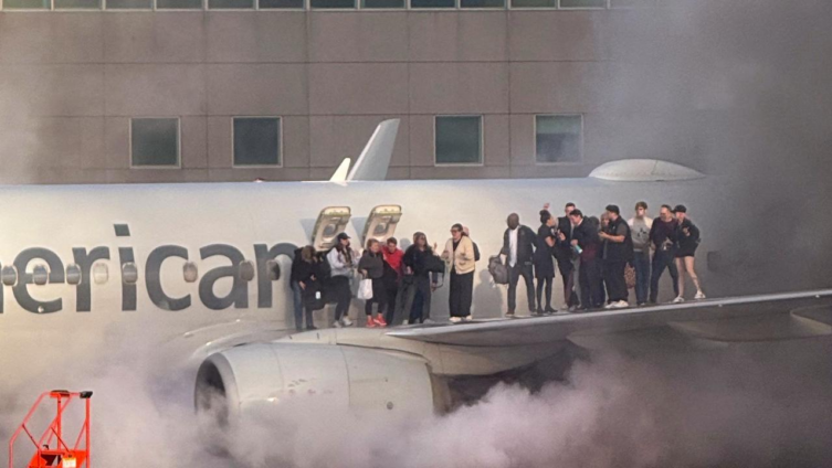 Passengers evacuate onto wing of burning American Airlines jet