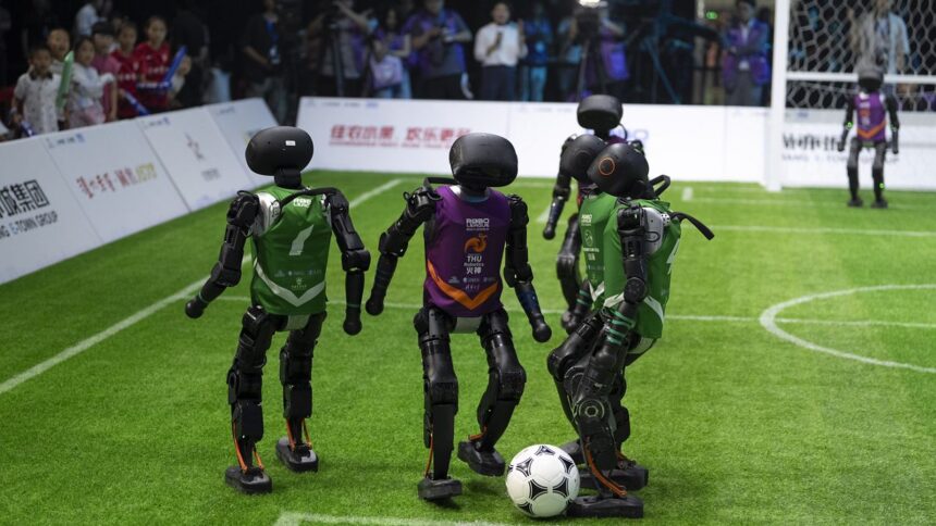 AI-powered robots play football in a Chinese soccer tournament